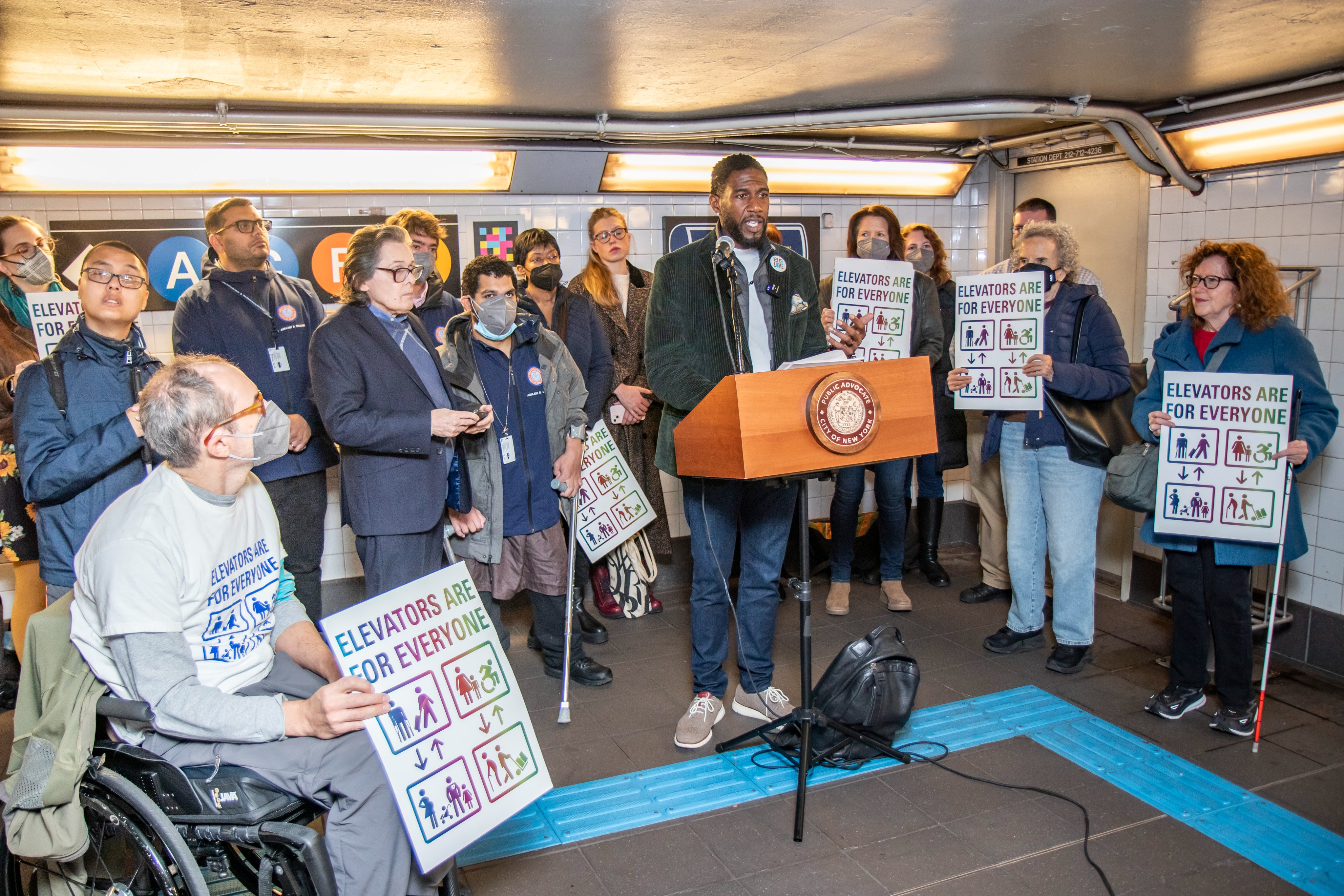 President Mike Schweinsburg and Vice President Ibrahim Alavante stand beside
	    	 Public Advocate Jumaane Williams and other disability advocates in mezzanine at 
	    	 Jay Street Metrotech station saying Elevators do not a fully accessible station
	    	  make